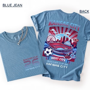 A blue jean back print shirt the front features a minimal "SOCCER CUP 26 KANSAS CITY" logo.