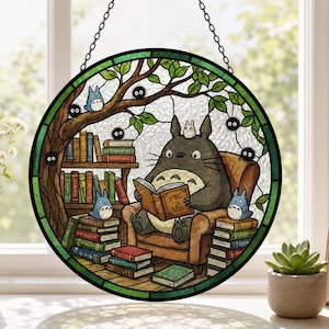 May include: Round stained glass window featuring a cartoon character reading a book in a cozy armchair. The scene includes stacks of books, a tree, and other characters. The window is framed with a green border and hangs from a chain.