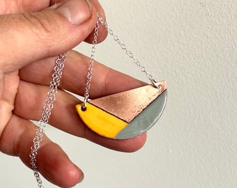 Enamel Semi circle Pendant with a geometric design in copper, yellow and grey