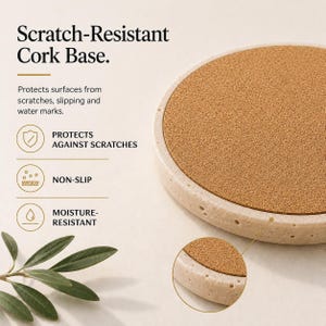 May include: A round coaster with a cork base and a light-colored, textured rim. The text on the image reads "Scratch-Resistant Cork Base." The coaster protects surfaces from scratches, slipping, and water marks.