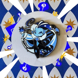 May include: Enamel pin featuring a blue-skinned character with white hair and a black and blue outfit. The pin is set against a white circle, with a blue and white diamond pattern and gold starbursts in the background.