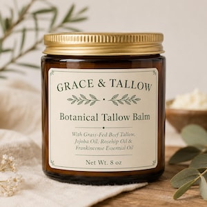 May include: An amber glass jar with a gold screw-top lid containing Botanical Tallow Balm. The cream-coloured label features the text Grace & Tallow, Botanical Tallow Balm, ingredients including grass-fed beef tallow, and Net Wt. 8 oz.