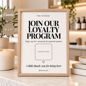 May include: A 5" x 7" vertical sign in a light wood frame with white background and black text reading THE STUDIO JOIN OUR LOYALTY PROGRAM Sign up for rewards & special perks, a square placeholder for a QR code, a heart icon, and @thestudio.
