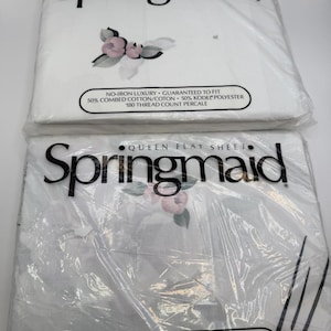 May include: Two packages of Springmaid queen-size bed sheets. The top package is a fitted sheet, and the bottom is a flat sheet. Both are white with a floral design and text that reads "NO-IRON LUXURY" and "180 THREAD COUNT PERCALE".