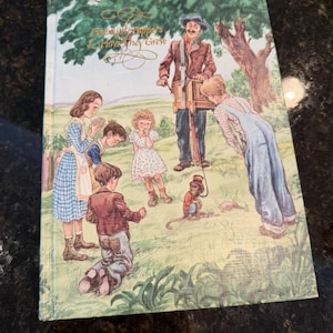 May include: Vintage children's book titled "Five Little Peppers & How They Grew." The cover features an illustration of a group of children and a man with a monkey on a leash, set in a grassy field with a tree in the background.
