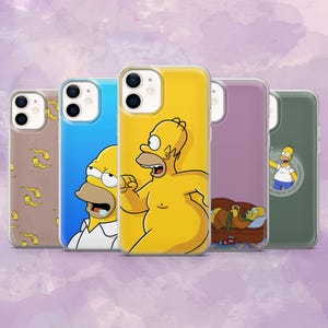 May include: A selection of clear phone cases showcasing images of Homer Simpson. The cases feature different scenes and characters from the animated series, including Homer in various poses and settings. The cases have a glossy finish.