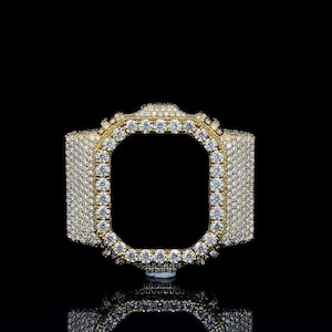 May include: A gold watch strap, lavishly adorned with many small, sparkling diamonds. The strap features a rectangular aperture in the centre and is set against a black backdrop, creating a luxurious and eye-catching accessory.