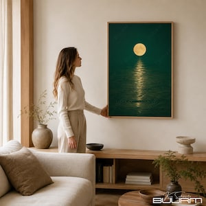 May include: A rectangular wall art print featuring a dark forest green background with a glowing yellow full moon centered at the top. The moon casts a bright, shimmering vertical reflection onto the rippling water surface below the moon.
