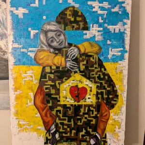May include: An original painting featuring a person with blonde hair, wearing a yellow shirt, embracing a figure with a camouflage pattern. The painting includes a broken heart and a yellow and blue background.