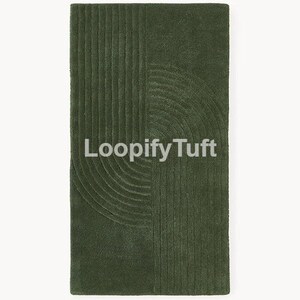 May include: A rectangular dark olive green tufted rug featuring a textured pattern of raised parallel lines that form two opposing semi-circular arch shapes. The text Loopify Tuft is printed in white across the center of the rug surface.