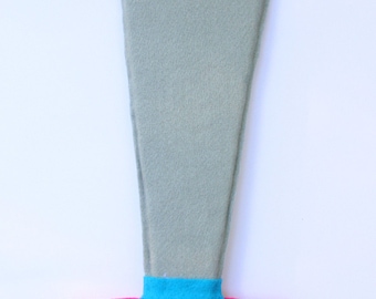 May include: A gray felt sword with a pink felt handle and a peace sign embroidered on the handle. The peace sign is outlined in yellow and blue thread.