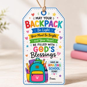 May include: A rectangular white gift tag with a jute string, featuring colorful text that reads: MAY YOUR BACKPACK BE LIGHT, YOUR MIND BE BRIGHT, AND YOUR HEART BE FILLED WITH GOD'S BLESSINGS. Includes a backpack illustration and HAVE AN AMAZING SCHOOL YEAR!