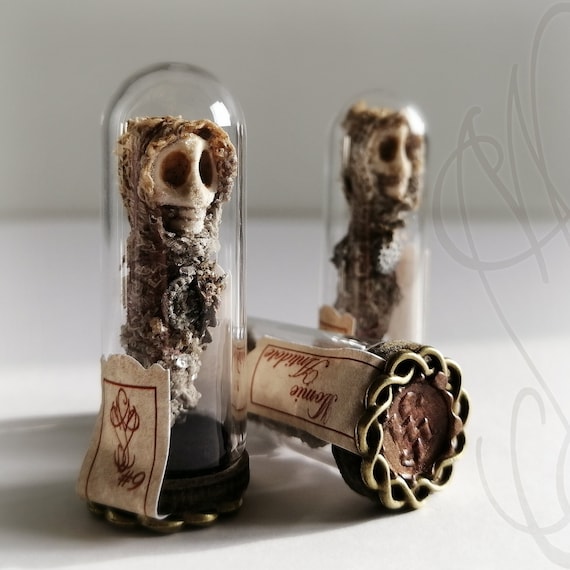 A tiny handcrafted mummy reliquary sculpture with 912 favorites — the kind of miniature macabre art that stops people in their tracks.