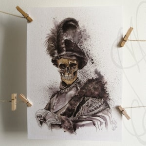 May include: Watercolor painting of a skeleton in antique armor and a feathered hat. The artwork features a gold-toned skull and is rendered in shades of black, gray, and brown. The image is attached to a wall with wooden clothespins.