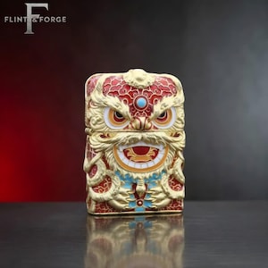 May include: A rectangular, ornate box with a lion-like design. The box is primarily gold with red, white, blue, and turquoise accents. The lion's face features detailed carvings and a turquoise gem. The text "FLINT & FORGE" is in the upper left corner.