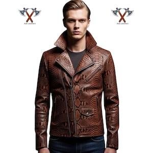 May include: Brown leather jacket with a snakeskin pattern, featuring a notched collar, asymmetrical zipper, and a small pocket. The jacket has a classic biker style with a textured appearance. The Axe Leathers logo is visible in the top corners.
