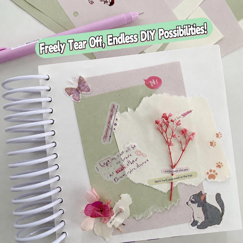 May include: A white spiral-bound notebook page decorated with layered paper scraps, a dried pink flower sprig, a butterfly sticker, a cat illustration, and text snippets including "I hope we can all be as brave as each other". A light purple pen lies nearby.