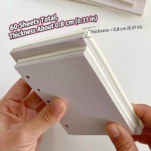 May include: A stack of white paper sheets with pre-punched holes along one side. The stack contains 60 sheets total with a thickness of approximately 0.8 cm (0.31 in). Text on the image reads: 60 Sheets Total, Thickness About 0.8 cm (0.31 in).