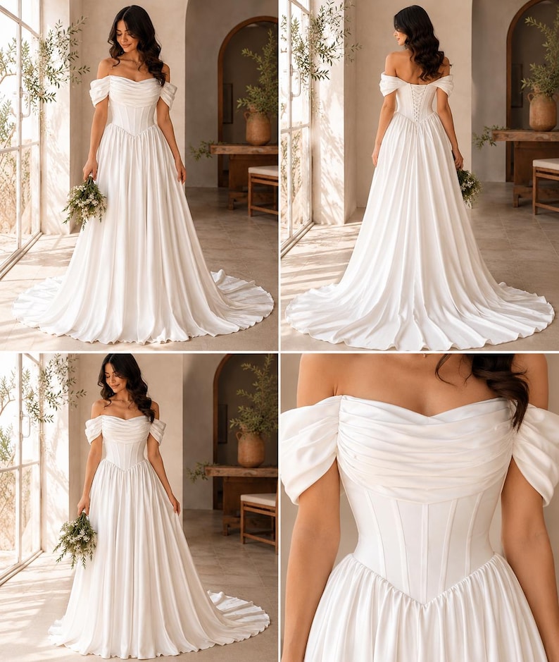 May include: A floor-length white gown featuring an off-the-shoulder neckline with draped fabric, a structured corset-style bodice with vertical boning, and a full, flowing skirt with a train. The back includes a lace-up closure detail.