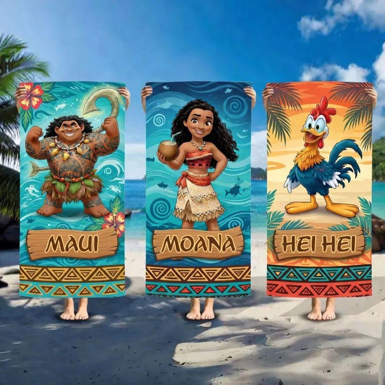 May include: Three colorful beach towels featuring characters from the animated movie Moana. The towels display Maui, Moana, and Hei Hei, each with their names on wooden signs. The backgrounds are themed to match each character.
