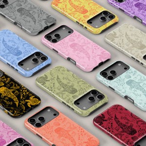 May include: A collection of colorful phone cases with a whale shark pattern. Cases are in various colors, including gray, yellow, pink, blue, green, and red. The whale shark design is repeated across the cases, along with other sea life.
