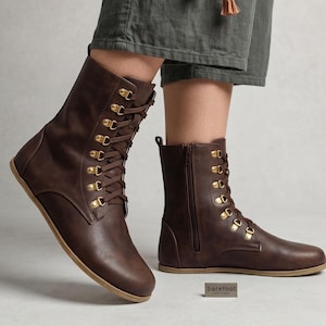 May include: Brown leather boots with a lace-up front and gold-colored eyelets. The boots have a side zipper and a flat sole. The text "fentybarefoot.etsy.com" is visible at the bottom of the image.