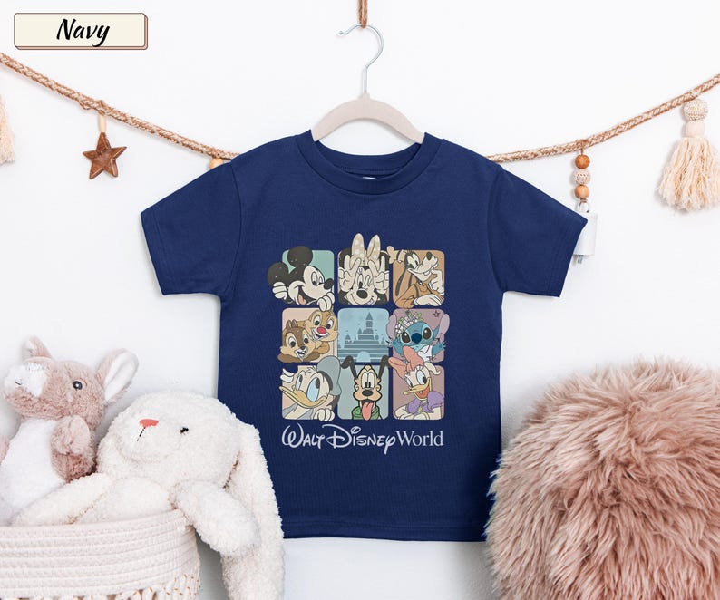 May include: A navy blue short-sleeve t-shirt featuring a grid graphic of various Disney characters including Mickey Mouse, Minnie Mouse, Goofy, Chip, Dale, Stitch, Donald Duck, Pluto, and Daisy Duck, with the text Walt Disney World printed below.