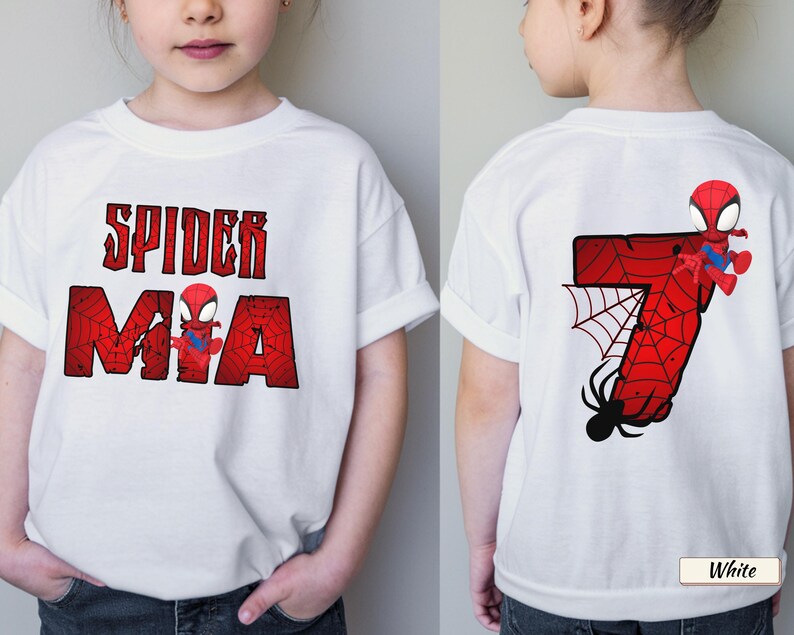 May include: White t-shirt featuring a Spider-Man graphic. The front displays "SPIDER MIA" in red, distressed lettering with a Spider-Man figure. The back shows a red number 7 with a spider web and Spider-Man.