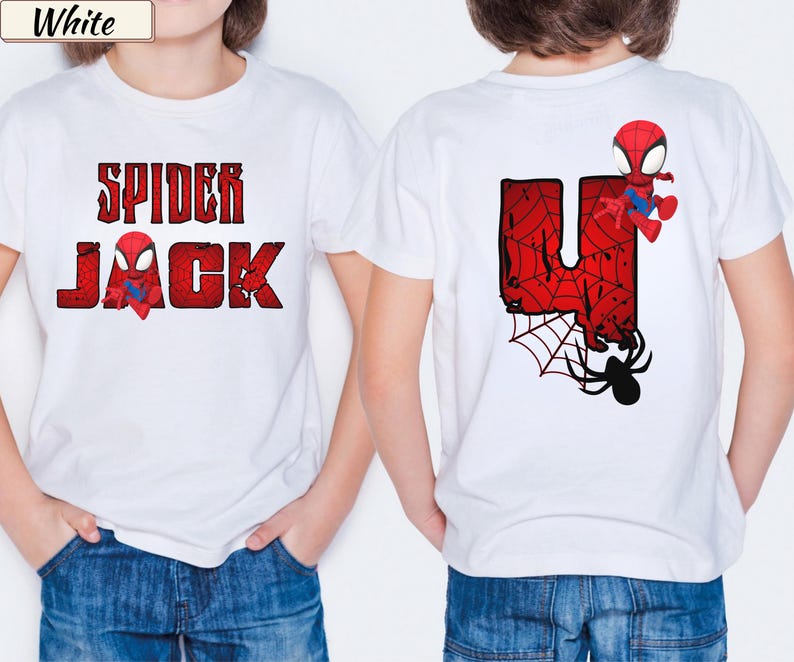 May include: White t-shirt with a red and black Spider-Man graphic. The front of the shirt says "SPIDER JACK" in a distressed font. The back features a large red "U" with a spider web design, a Spider-Man character, and a black spider.