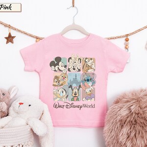May include: A light pink short-sleeve t-shirt featuring a grid of nine squares with various Disney characters including Mickey Mouse, Minnie Mouse, Goofy, Chip, Dale, Stitch, Donald Duck, Pluto, and Daisy Duck, with the text Walt Disney World.