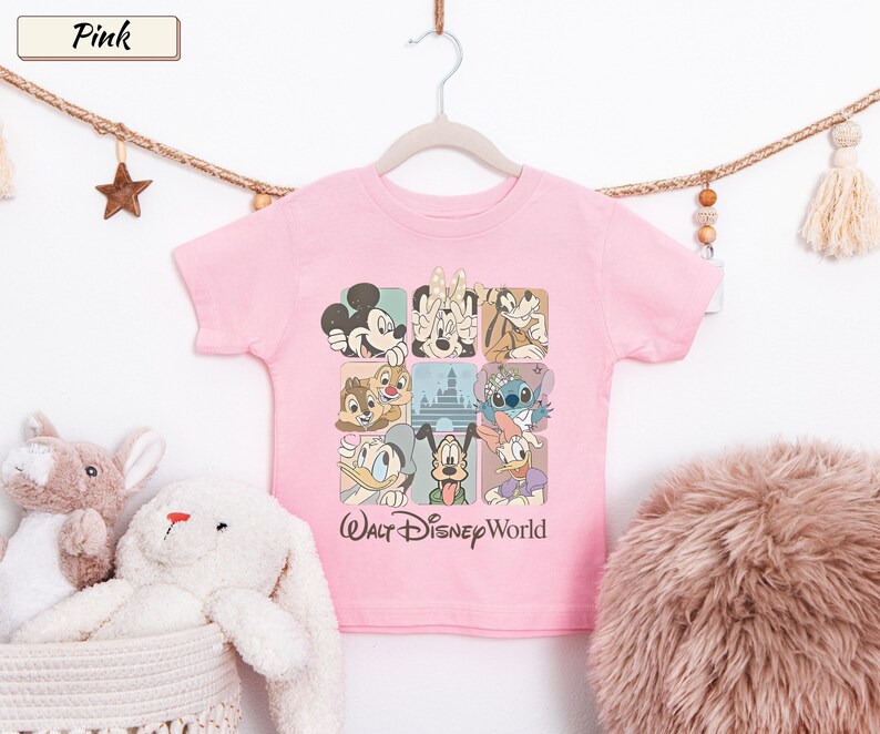 May include: A light pink short-sleeve t-shirt featuring a grid of nine squares with various Disney characters including Mickey Mouse, Minnie Mouse, Goofy, Chip, Dale, Stitch, Donald Duck, Pluto, and Daisy Duck, with the text Walt Disney World.