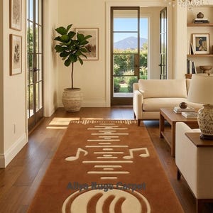 May include: A brown rectangular rug with a musical theme, featuring white musical notes and sound wave patterns. The rug is in a living room with hardwood floors and a view of the outdoors. The text "Aliya Rugs Carpet" is visible on the rug.