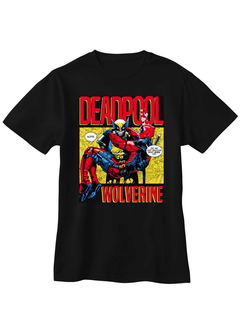May include: Black t-shirt with a comic book illustration of Deadpool and Wolverine. The design features the words "DEADPOOL" and "WOLVERINE" in red and yellow. The characters are depicted in a dynamic pose with speech bubbles.
