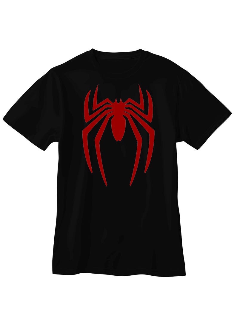 May include: A black short-sleeved t-shirt featuring a large, centered red spider graphic on the chest. The spider design has elongated, pointed legs and a solid red body, contrasting sharply against the plain black fabric of the garment.