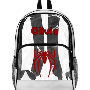 May include: Clear backpack with black and white striped design, a red spider graphic, and the name "Olivia" in red. Features a black handle and white bottom.