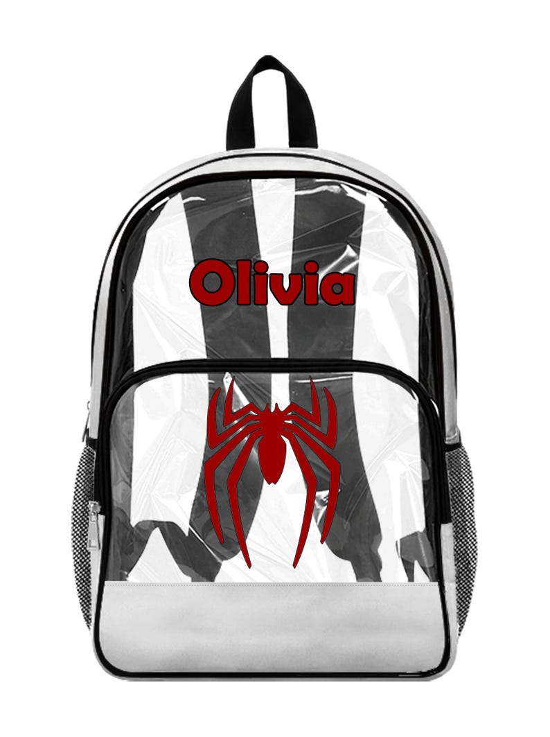 May include: Clear backpack with black and white striped design, a red spider graphic, and the name "Olivia" in red. Features a black handle and white bottom.