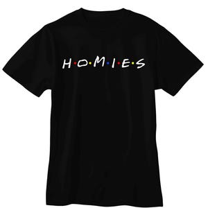 May include: A black short-sleeved t-shirt featuring the white text "H.O.M.I.E.S" printed across the chest. The letters are separated by small colored dots in red, blue, and yellow, mimicking a classic television show logo style.