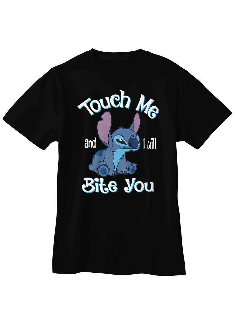 May include: Black t-shirt featuring a blue cartoon character with large ears. The character is sitting and has the text "Touch Me and I will Bite You" in white and light blue. The shirt is a short-sleeved crew neck.