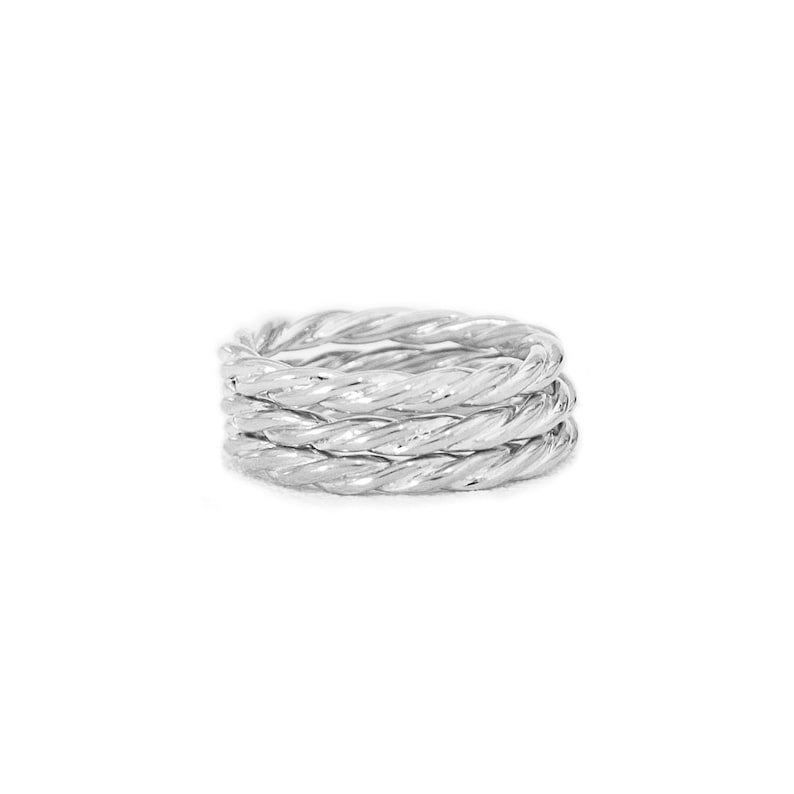 May include: A silver ring with a twisted rope design. The ring is made of multiple strands of silver that are twisted together to create a rope-like effect.