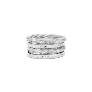 May include: A set of five silver rings stacked together. Each ring has a twisted, textured design.