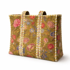 May include: A quilted tote bag with a floral pattern in shades of pink, red, blue, and yellow on an olive green background. The bag has two handles and is trimmed with yellow and white striped fabric.