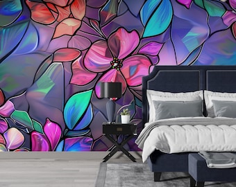 May include: A bedroom featuring a dark blue upholstered bed with a matching bench and a black nightstand. The wall behind the bed is covered in wallpaper with a stained glass pattern of vibrant pink, purple, and teal floral shapes.