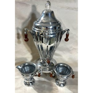 May include: A set of three ceramic vases in varying heights. The vases are white with a textured, ribbed design. The tallest vase is approximately 10 inches tall, the medium vase is 8 inches, and the smallest is 6 inches.