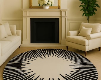 May include: A large circular area rug featuring a cream-coloured centre surrounded by a radiating pattern of thick, black, tapered lines that extend outward towards the edge, creating a bold, high-contrast sunburst design on the floor.
