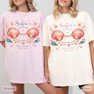 May include: Two t-shirts, one pink and one cream, with a seashell design. The text reads "Sofia's BACH BASH" and "Miami, Florida, AGUST 2026". The design includes seashells, flowers, and gold chain accents.