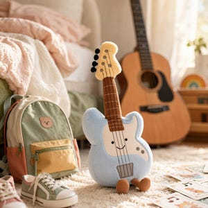 May include: A plush blue guitar with a smiling face and brown details sits on a fluffy white rug. A green and peach backpack, sneakers, and a wooden acoustic guitar are in the background. Sheet music is scattered on the rug.