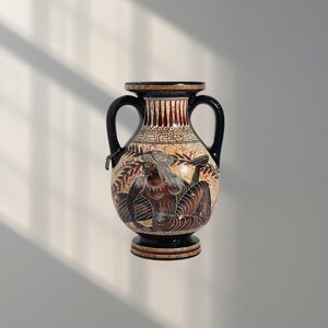 May include: A two-handled, antique-style vase with a black rim and handles. The vase features a detailed illustration of a figure in shades of brown, black, and white. The design includes geometric patterns and a decorative border.