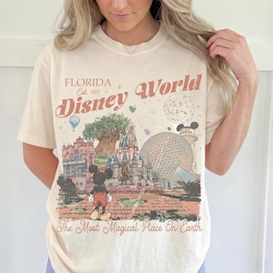 Comfort Colors Mickey Disneyworld shirt featuring a retro Mickey and Friends design. Perfect for your 2026 Disney trip or Disney vacation. Celebrate your magical experience with this stylish tee, ideal for family trips, group outings, and park days at Walt Disney World and Magic Kingdom. A must-have for Disney lovers! Mickey graphic tee for all ages.