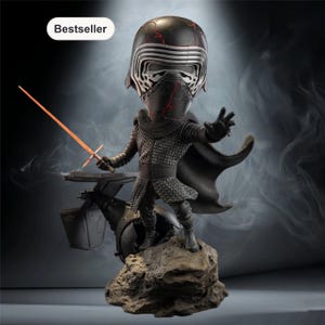 May include: A black Kylo Ren bobblehead figure with a red lightsaber. The figure is standing on a rock base with a black vehicle behind it. The figure is wearing a black helmet and armor. The word "Bestseller" is in a white box in the upper left corner.