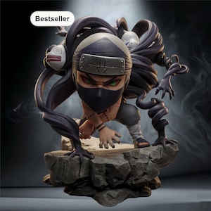 May include: A detailed figurine of a character in a crouching pose, with a black mask, headband, and green eyes. The figure is surrounded by dark, swirling tendrils and stands on a rocky base. The word "Bestseller" is in a white box.